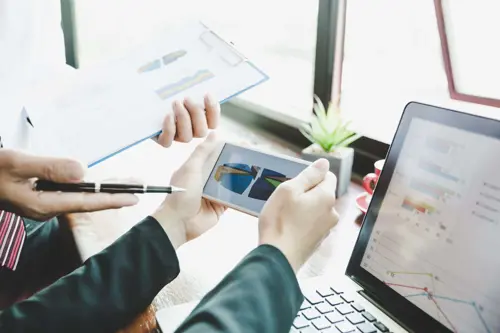 business-team-analyzing-income-charts-graphs-smartphone-close-up